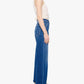 A woman stands in profile against a plain white background wearing the Mother Petites Lil Patch Maven Sneak: high-waisted, wide-leg blue jeans made from recycled stretch denim, paired with a white sleeveless top.