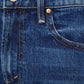 Close-up of the waistband and front pocket of dark blue Petites Lil Bookie Twist Skimp jeans, featuring copper-colored rivets and stitching.