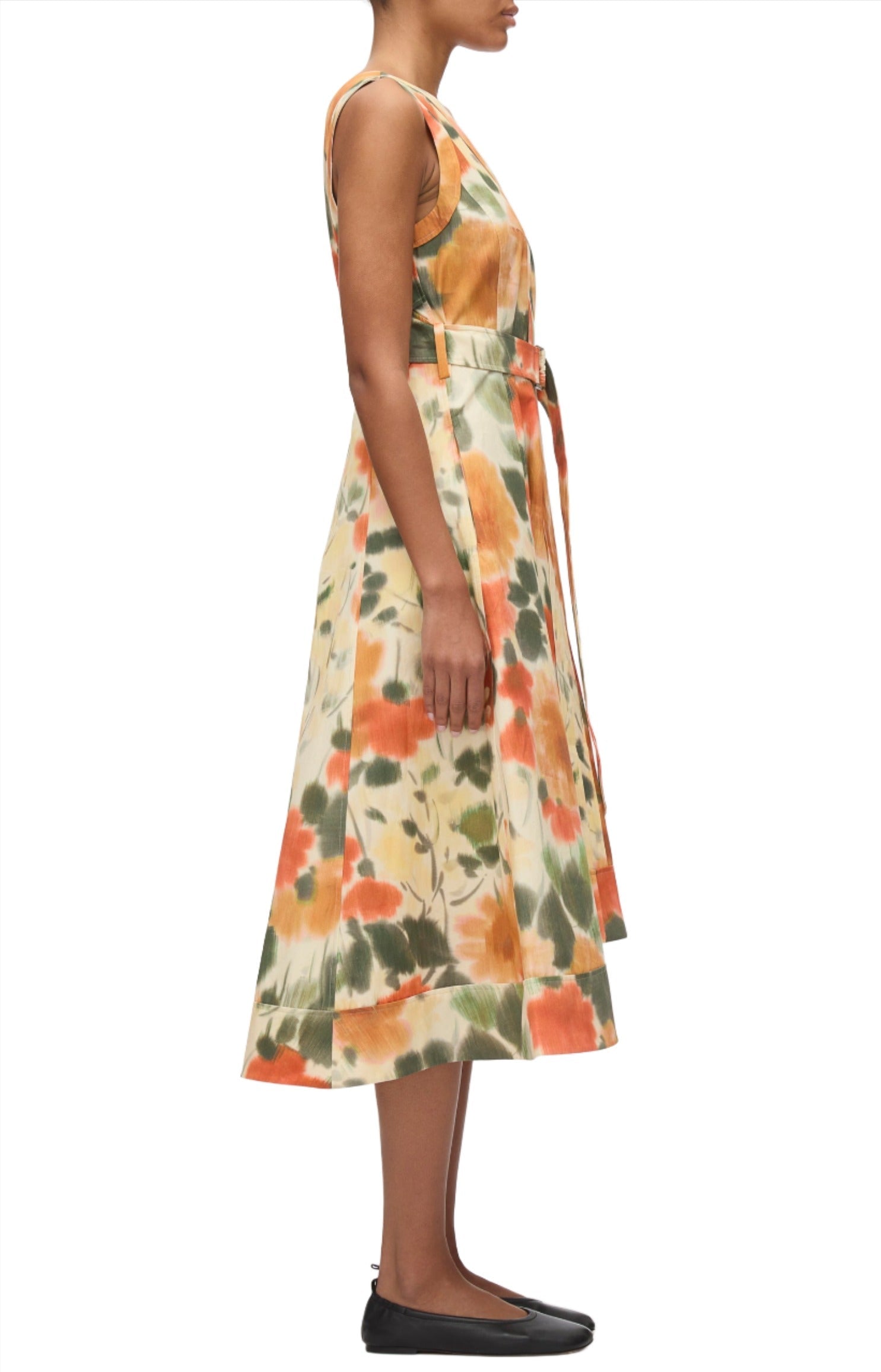 A person is wearing a 3.1 Phillip Lim Blurred Marigold Belted Midi Dress, standing in a side profile view.