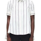 A person wearing the Adam Lippes Trapeze Stripe Shirt—a short-sleeve, ivory and black striped button-up—and black pants, photographed from the front.