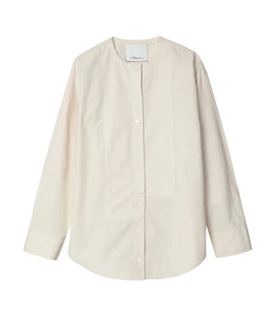 The 3.1 Phillip Lim Collarless Cotton Poplin Shirt features long sleeves and an off-white, band collar design, evoking a modernist painter’s smock, displayed laid flat on a white background.