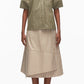 A woman wears the 3.1 Phillip Lim Stripe Lantern Sleeve Shirt in olive green with a beige striped midi skirt featuring asymmetrical layers and an A-line silhouette, paired with white shoes.