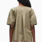 A person stands facing away, wearing the 3.1 Phillip Lim Stripe Lantern Sleeve Shirt with vertical white stripes and sculptural sleeves, paired with a matching skirt.