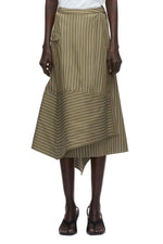 A person wears the 3.1 Phillip Lim Stripe Wrap Asymmetrical Hem Skirt—green and white pinstriped with a handkerchief hem and side pocket—paired with black sandals.