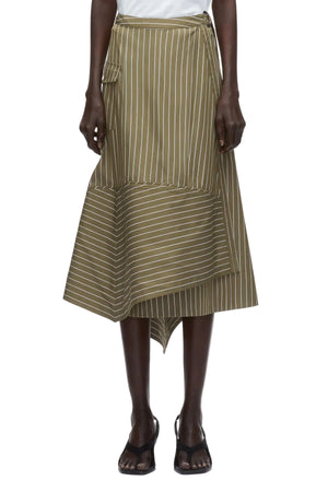 A person wears the 3.1 Phillip Lim Stripe Wrap Asymmetrical Hem Skirt—green and white pinstriped with a handkerchief hem and side pocket—paired with black sandals.