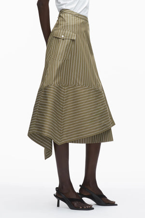 A person models the 3.1 Phillip Lim Stripe Wrap Asymmetrical Hem Skirt with a handkerchief hem and large side pocket, paired with black heeled sandals, set against a white background.
