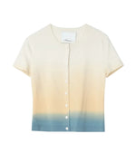 The 3.1 Phillip Lim Light Weight Button Up Dip Dye Tee is a short-sleeve, fitted cardigan featuring an ombré gradient that shifts from cream to beige to light blue at the hem.