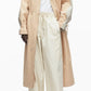 A person wears the 3.1 Phillip Lim Blouson Trench Coat over a white t-shirt and loose cream pants, standing against a plain white background.