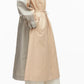 A person in profile wears the 3.1 Phillip Lim Blouson Trench Coat—a long, modern two-tone cotton-viscose twill coat with a drawstring waist—over wide-leg pants, standing against a plain background.