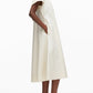 A person stands in profile wearing the 3.1 Phillip Lim Trapeze Midi Poplin Shirt Dress with side pockets and black heeled mules against a plain white background.