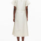 A person stands facing away, wearing the 3.1 Phillip Lim Trapeze Midi Poplin Shirt Dress in off-white with black heels against a plain white background.