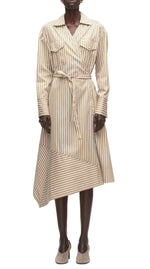 A person wears the 3.1 Phillip Lim Stripe Poplin Asymmetrical Wrap Shirt Dress—beige and white striped cotton poplin with a belted waist and handkerchief hem—paired with beige shoes.