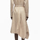 A person is seen from the back in the 3.1 Phillip Lim Stripe Poplin Asymmetrical Wrap Shirt Dress, featuring tan and white vertical stripes, a belted waist, and a handkerchief hem.