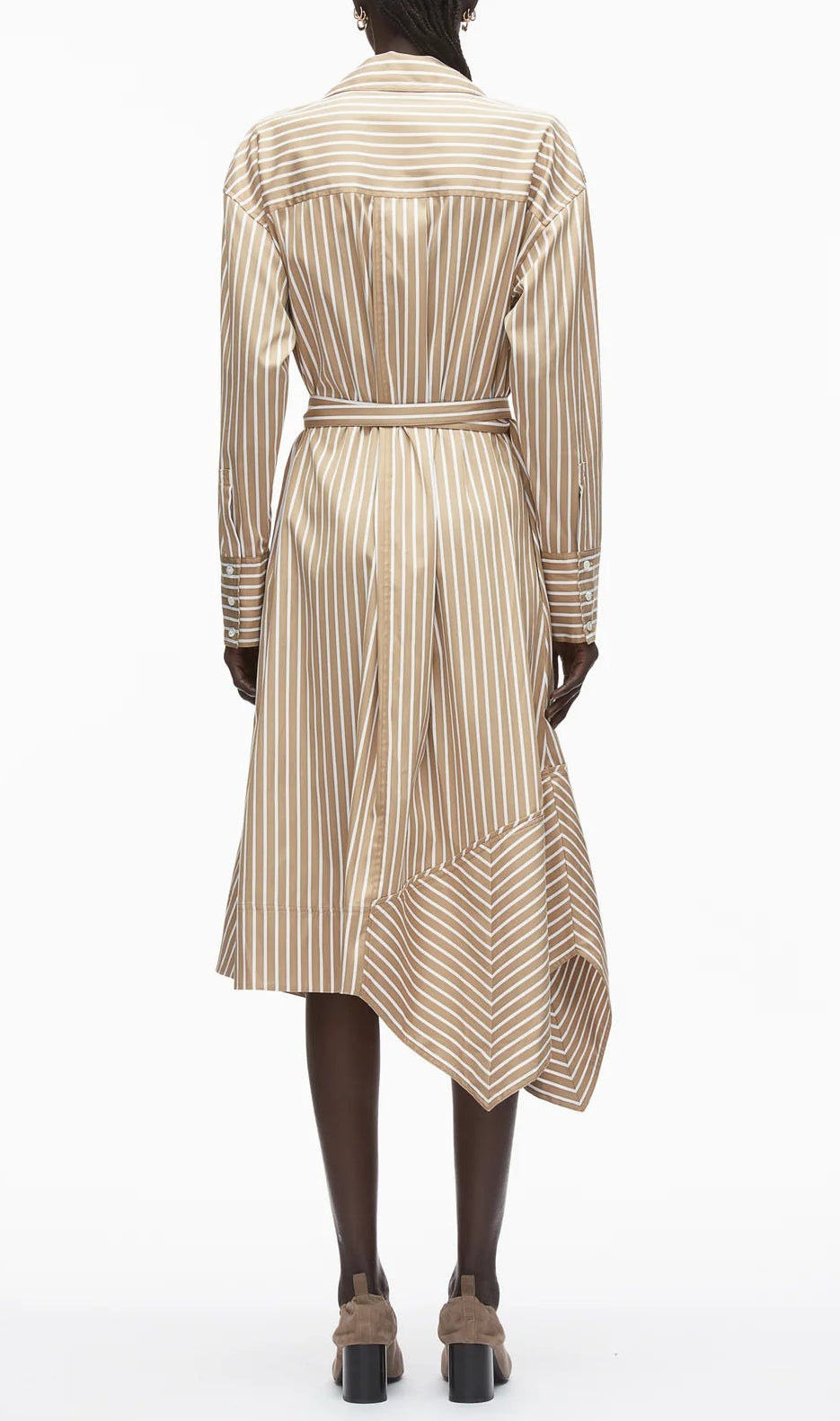 A person is seen from the back in the 3.1 Phillip Lim Stripe Poplin Asymmetrical Wrap Shirt Dress, featuring tan and white vertical stripes, a belted waist, and a handkerchief hem.
