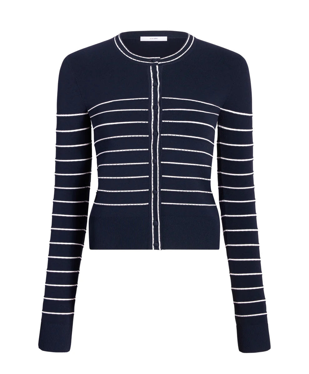 The Faye Cardigan by Adam Lippes is a navy jacquard knit cardigan with long sleeves and white horizontal stripes, featuring a button-down front and a round neckline.