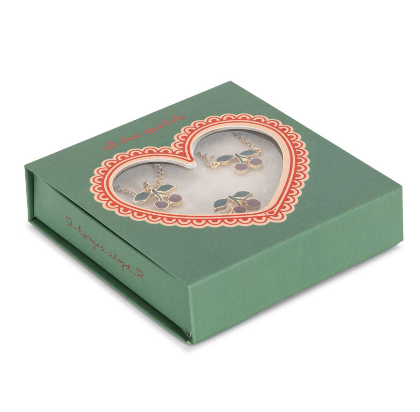 Konges Slojd Jewelery Set: A gold and purple earrings and necklace duo presented in a green gift box with a heart-shaped window.