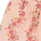 Close-up of Konges Slojd Baby Girls' and Girls' Coco Shorts in light pink muslin, featuring an elastic waistband and a floral print with red, yellow, and purple flowers plus green leaves.