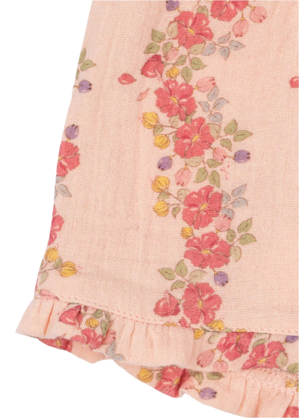 Close-up of Konges Slojd’s Baby Girls' and Girls' Coco Shorts in breathable pink muslin with a floral print, green leaves, and a ruffled hem—perfect for comfort and style.