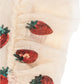 Close-up of the Girls' Yvonne Frill Dress by Konges Slojd, made from sheer beige fabric with ruffled edges and voluminous red and green sequin strawberry embroidery—ideal for a whimsical tulle look.