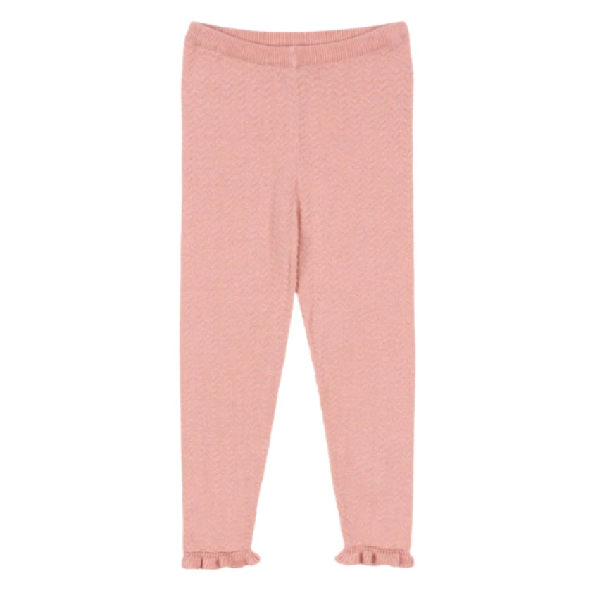 The Konges Slojd Baby Girls' and Girls' Cypres Pants feature light pink knit fabric with a subtle zigzag pattern and delicate frills at the hems, shown against a plain white background.