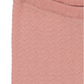 Close-up of the Konges Slojd Baby Girls' and Girls' Cypres Pants, featuring textured light pink knit fabric, a ribbed waistband at the top, and neat hems.