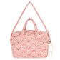 The Konges Slojd Lacy Pink Doll Bag is a quilted pink carryall with soft straps, grab handle, heart pattern, and front pocket—perfect for stylish doll outings.