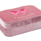 The Konges Slojd All I Wish For Jewellry Set comes in a rectangular pink velvet box with an embroidered bow on the lid—ideal for storing kids' jewelry and dress-up accessories.
