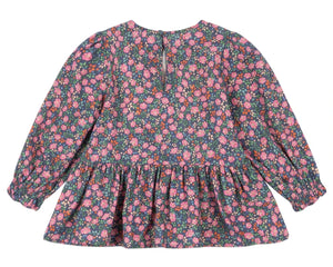 The Girls' Cianna Blouse by Konges Slojd is a long-sleeved, floral-patterned cotton top for children featuring a gathered waist and back button closure.