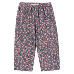 The Konges Slojd Girls' Cianna Pants are loose-fitting, soft pants with an elastic waist, showcasing a dark background and an all-over pink and green floral print.