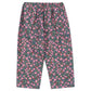 The Girls' Cianna Pants by Konges Slojd are loose-fitting and soft, with a comfy elastic waist and a dark base adorned with an all-over pink and purple floral print.