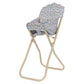 The Konges Slojd Doll High Chair features a foldable beige metal frame with a floral-patterned, detachable seat and backrest.