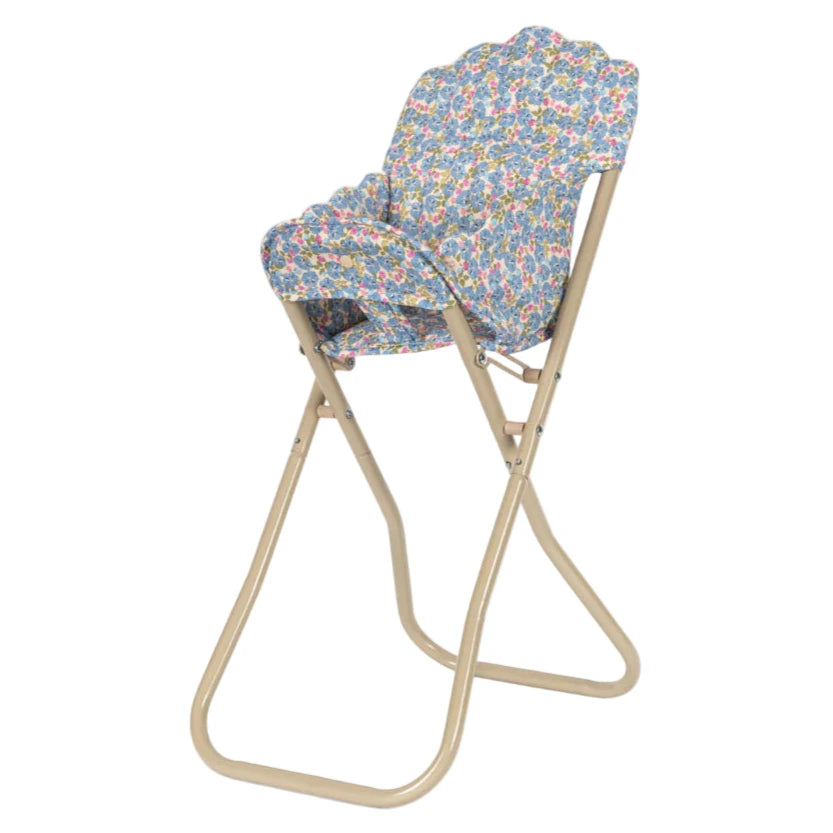 The Konges Slojd Doll High Chair features a foldable beige metal frame with a floral-patterned, detachable seat and backrest.