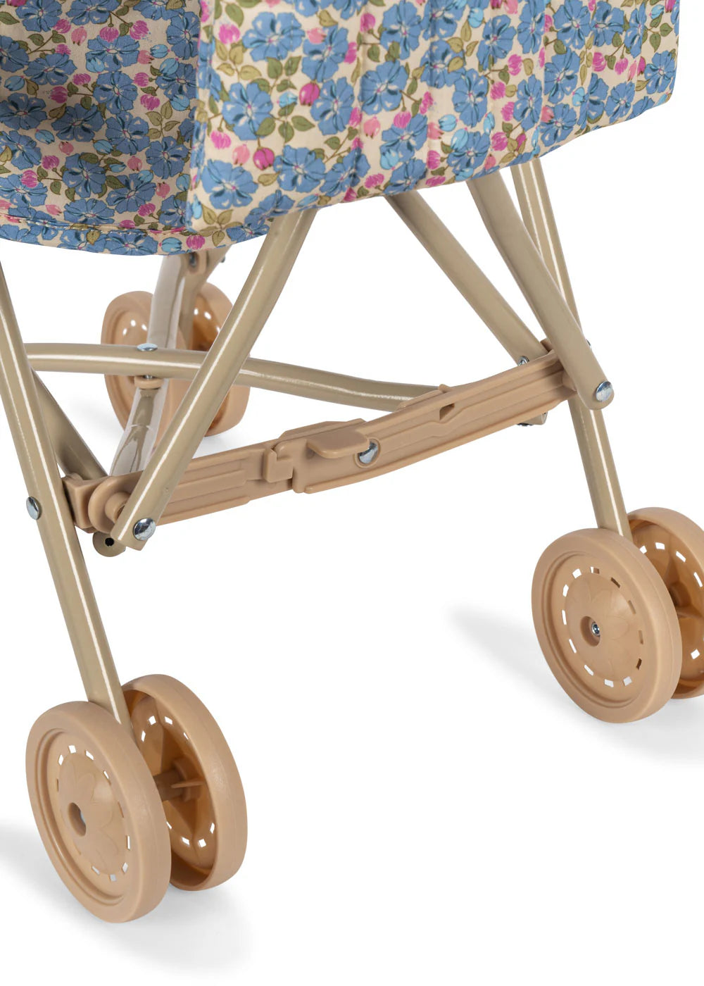 Close-up of the lower part of the Konges Slojd Doll Stroller, featuring double wheels and a beige floral-patterned fabric covering.