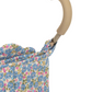 Close-up of a beige foam handle on the Konges Slojd Doll Stroller, shown with blue and pink floral fabric, showcasing the elegant design.