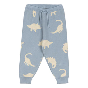 Konges Slojd Baby Boys' and Boys' Lapis Knit Pants feature a light blue jacquard knit with an elastic waist, drawstring, relaxed fit, and beige dinosaur silhouettes throughout.