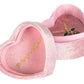 The Little Necklace Box by Konges Slojd is a pink velvet heart-shaped jewellery box with gold cursive writing and a heart inside the lid, elegantly holding a necklace with a cherry pendant.