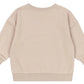 The Baby Boys' and Boys' Lou Sweat Shirt by Konges Slojd is shown from the back in beige, featuring ribbed cuffs, hem, and collar. Made from soft organic cotton for comfortable everyday wear.