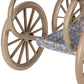 Close-up of the Minnie Doll Pram by Konges Slojd, a foldable vintage-style doll stroller with beige wheels and blue, purple, and yellow floral fabric.