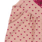 Close-up of Konges Slojd's Baby Girls' and Girls' Nola Sequin Overalls in pink, adorned with small red hearts, a large sequined heart on the chest, and charming logo buttons.