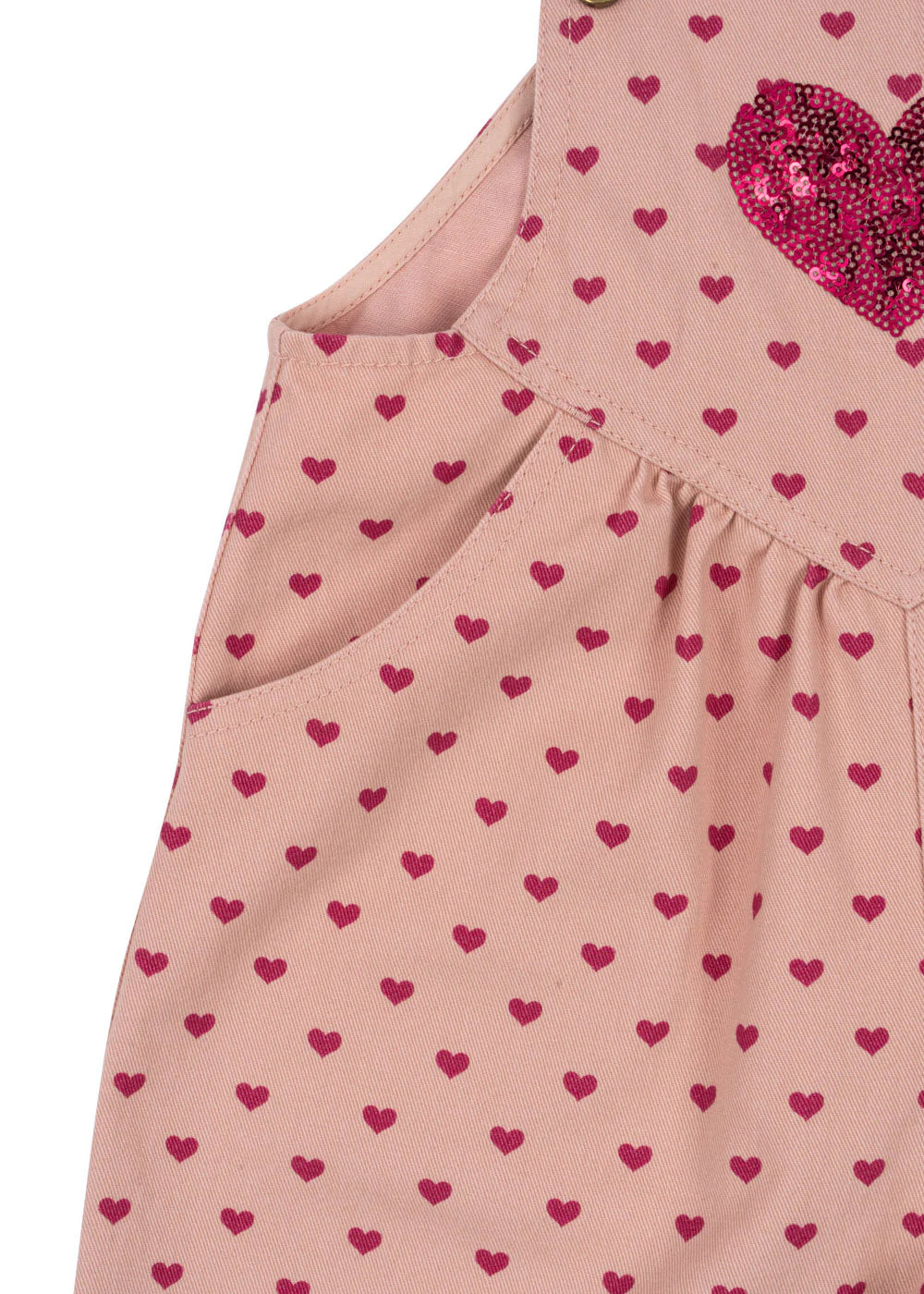 Close-up of Konges Slojd's Baby Girls' and Girls' Nola Sequin Overalls in pink, adorned with small red hearts, a large sequined heart on the chest, and charming logo buttons.