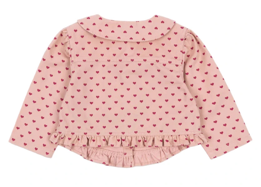 The Konges Slojd Baby Girls' and Girls' Nola Sequin Shirt Jacket is shown from the back, featuring light pink fabric, long sleeves, a Peter Pan collar, red heart pattern, and frill hems along the bottom.