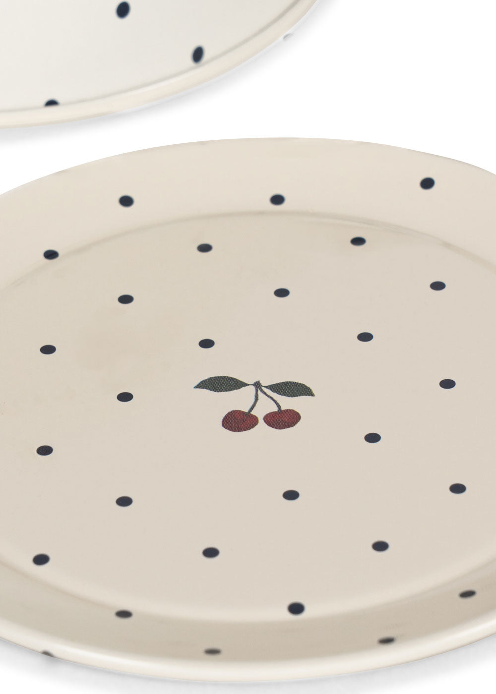 Off-white plates from the Konges Slojd Blue Dot Tea Party Set, featuring blue polka dots and a small cherry illustration in the center.