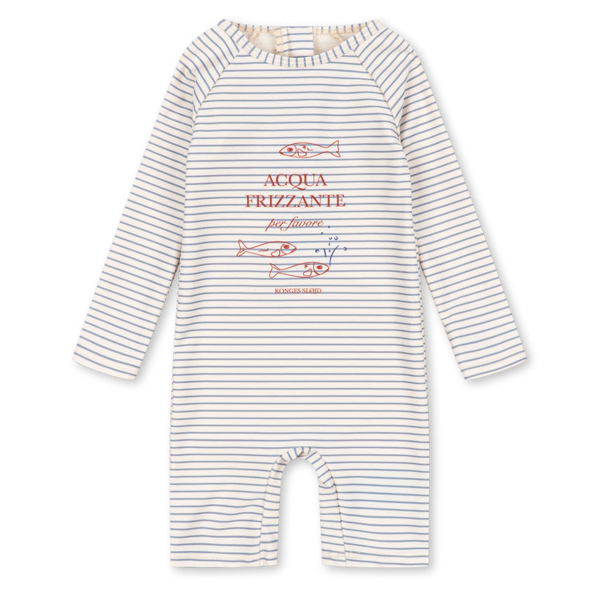 The Baby Boys’ Aster Onesie Swimsuit by Konges Slojd features long sleeves and classic stripes, with cheerful “ACQUA FRIZZANTE” text and fish illustrations printed in red and blue on the front. Designed to provide a comfortable fit, this romper also adds a layer of UV protection for little ones during sunny days.