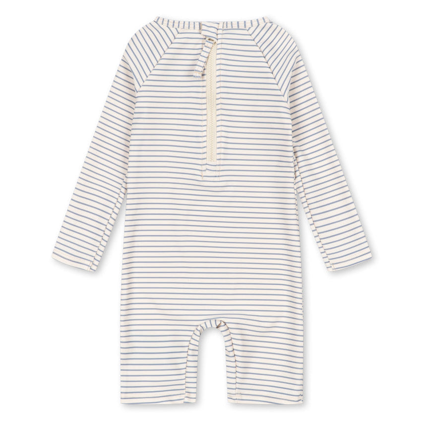 The Konges Slojd Baby Boys’ Aster Onesie Swimsuit is a long-sleeve romper featuring thin horizontal stripes and a front zipper closure, designed as a swim onesie with built-in UV protection, shown on a white background.