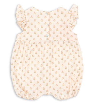 Back view of the Konges Slojd Baby Girls’ Coco Frill Romper, featuring breathable fabric, ruffled sleeves, an all-over delicate floral print, and buttons down the top half for easy dressing.