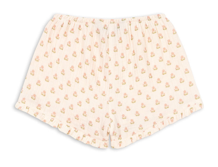 Konges Slojd Baby Girls’ and Girls’ Coco Shorts, featuring a light color, elastic waistband, small floral print pattern, and subtle ruffles at the hem, displayed on a white background.