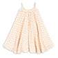 The Girls’ Coco Strap Dress by Konges Slojd is a sleeveless, cream-colored summer dress with thin straps and a loose, flared skirt, adorned with a delicate pink floral pattern throughout. This soft dress offers an easy, breezy style that’s perfect for warm days.