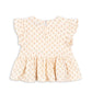 The Konges Slojd Baby Girls’ and Girls’ Coco Top is a light cream blouse featuring a charming small floral print, flutter sleeves, a ruffled peplum silhouette hem, and a back button keyhole closure, displayed flat on a white background.