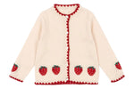 The Girls' Collette Cardigan by Konges Slojd features a cream knit with red strawberry embroidery on the hem and sleeves, red scalloped edges, and mother of pearl button closure.