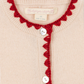 A close-up of the Girls' Collette Cardigan by Konges Slojd, adorned with delicate strawberry embroidery and finished with mother of pearl buttons.